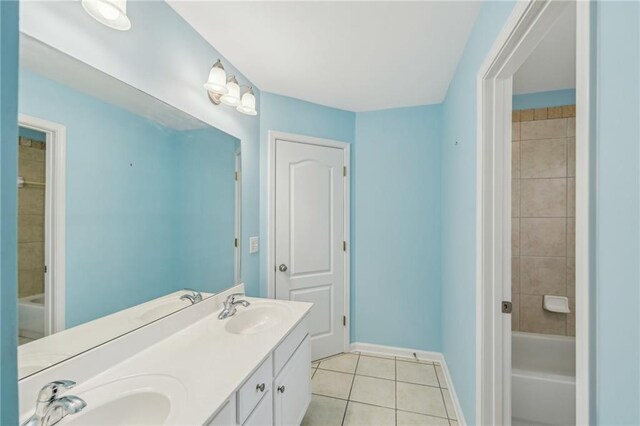 2143 Great Shoals Cir, Lawrenceville, GA 30045 - bathroom featuring double vanity, baseboards, a sink, and tile patterned floors
