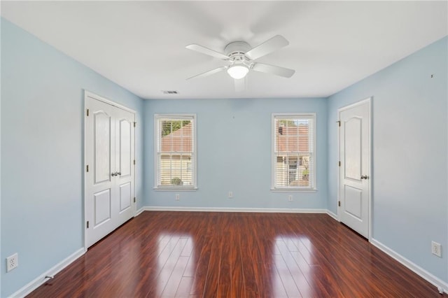 2143 Great Shoals Cir, Lawrenceville, GA 30045 - spare room featuring a ceiling fan, baseboards, visible vents, and dark wood-style flooring