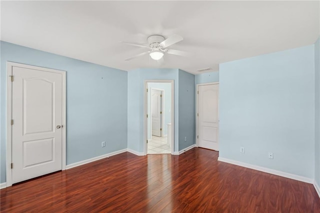 2143 Great Shoals Cir, Lawrenceville, GA 30045 - unfurnished bedroom featuring dark wood-style floors, visible vents, ensuite bathroom, ceiling fan, and baseboards