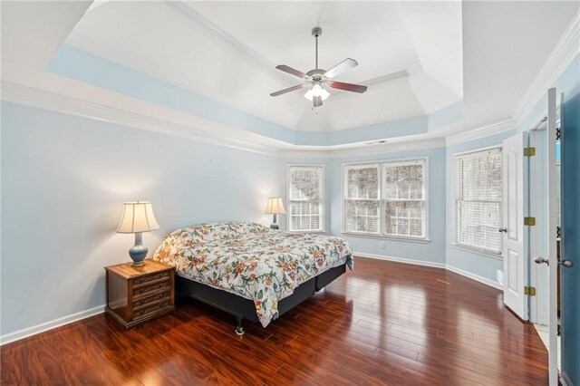 2143 Great Shoals Cir, Lawrenceville, GA 30045 - bedroom with baseboards, dark wood finished floors, a ceiling fan, ornamental molding, and a tray ceiling