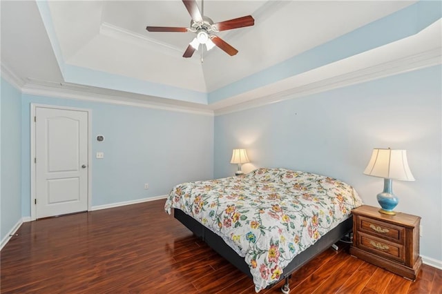 2143 Great Shoals Cir, Lawrenceville, GA 30045 - bedroom with dark wood-style flooring, a ceiling fan, baseboards, a tray ceiling, and crown molding