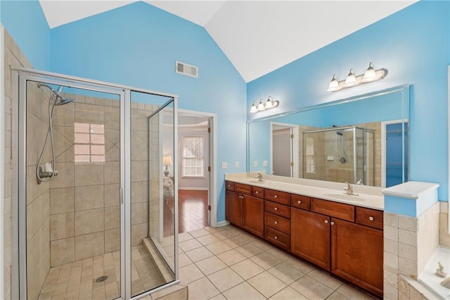 2143 Great Shoals Cir, Lawrenceville, GA 30045 - full bath with double vanity, visible vents, vaulted ceiling, and a sink