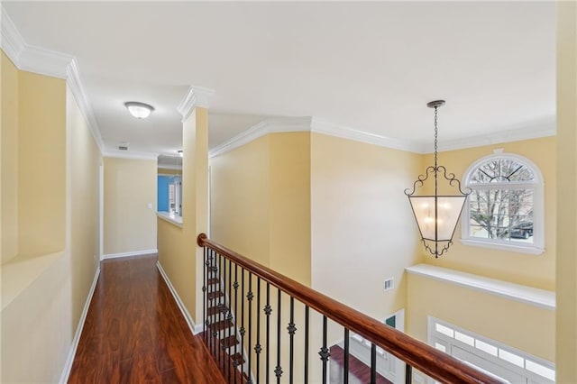 2143 Great Shoals Cir, Lawrenceville, GA 30045 - hall with baseboards, visible vents, ornamental molding, dark wood-style flooring, and an upstairs landing