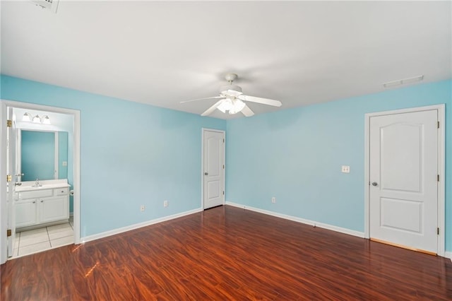 2143 Great Shoals Cir, Lawrenceville, GA 30045 - unfurnished bedroom featuring baseboards, visible vents, connected bathroom, ceiling fan, and wood finished floors
