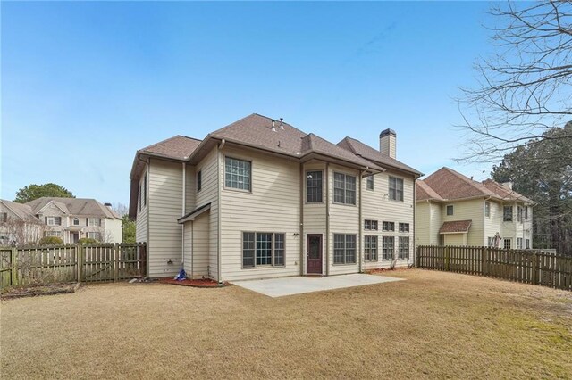 2143 Great Shoals Cir, Lawrenceville, GA 30045 - back of property with a patio area, a fenced backyard, a chimney, and a yard