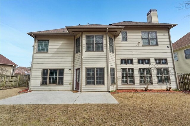 2143 Great Shoals Cir, Lawrenceville, GA 30045 - back of house featuring a fenced backyard, a chimney, a lawn, and a patio