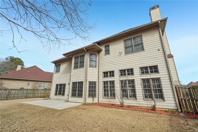 2143 Great Shoals Cir, Lawrenceville, GA 30045 - rear view of house with a chimney, fence, a lawn, and a patio