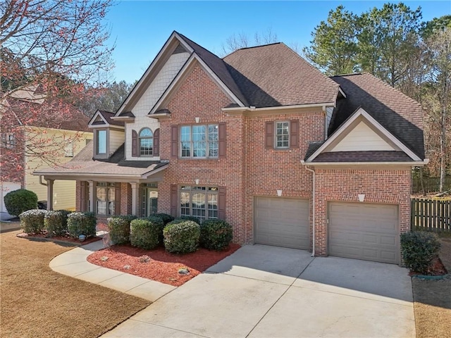 2143 Great Shoals Cir, Lawrenceville, GA 30045 - craftsman house with an attached garage, covered porch, brick siding, concrete driveway, and roof with shingles