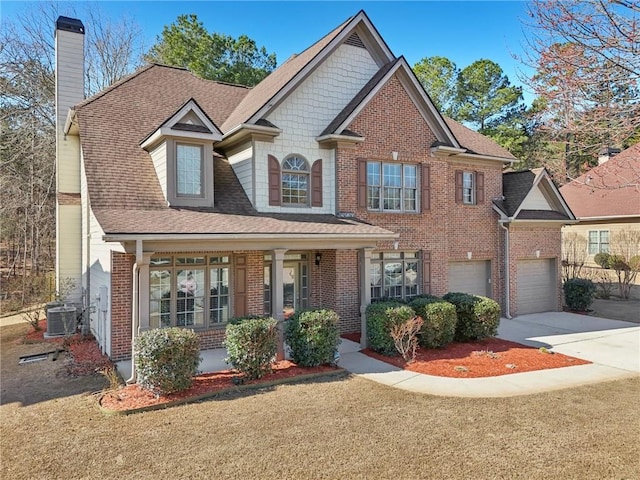 2143 Great Shoals Cir, Lawrenceville, GA 30045 - craftsman house featuring driveway, a chimney, covered porch, central air condition unit, and a front yard