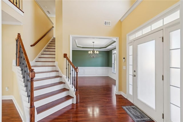2143 Great Shoals Cir, Lawrenceville, GA 30045 - entryway with ornamental molding, visible vents, and dark wood finished floors