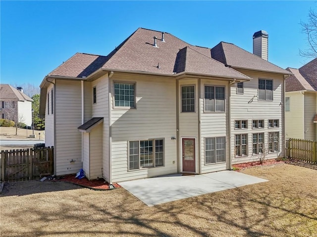 2143 Great Shoals Cir, Lawrenceville, GA 30045 - rear view of property with a shingled roof, a fenced backyard, a patio, and a chimney