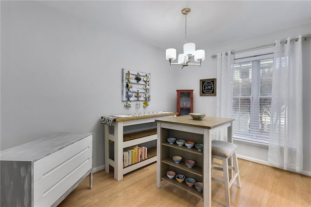 dining area featuring a chandelier and light hardwood / wood-style floors