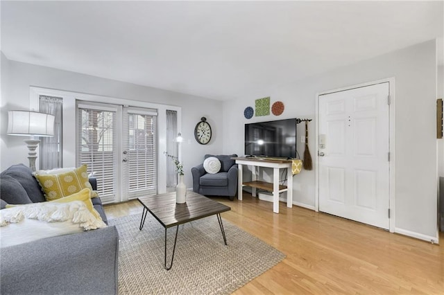 living room featuring french doors and hardwood / wood-style flooring