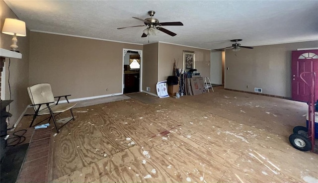 unfurnished living room with visible vents, crown molding, baseboards, ceiling fan, and a textured ceiling