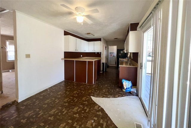 kitchen with light countertops, white cabinets, plenty of natural light, and ceiling fan