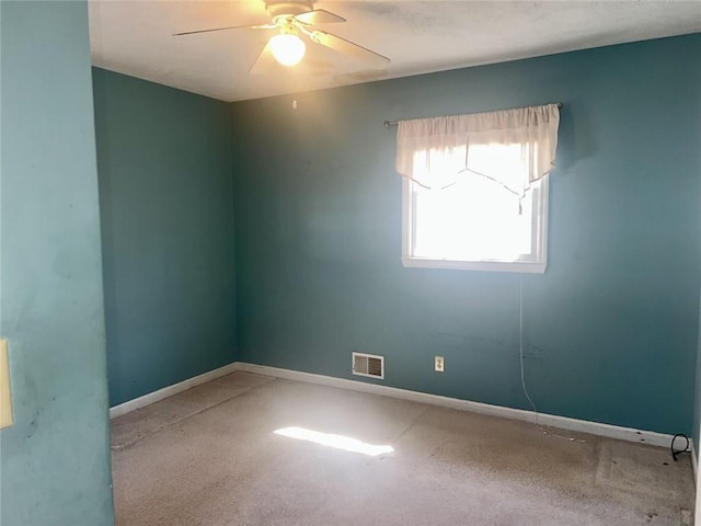 unfurnished room featuring visible vents, baseboards, and a ceiling fan