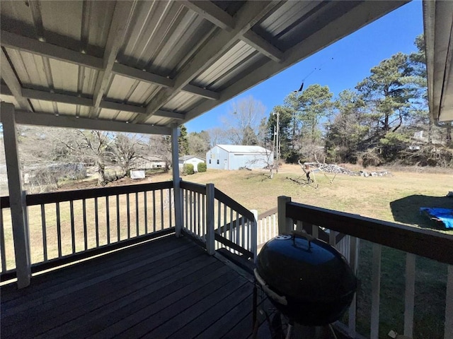 wooden terrace with a yard and area for grilling