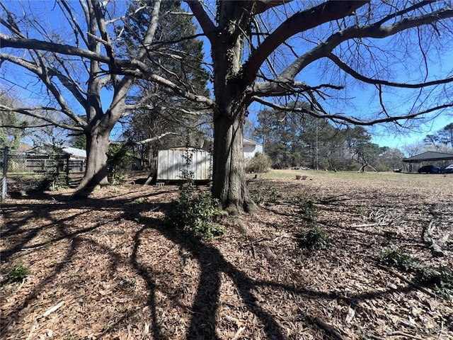 view of yard with a storage unit and an outbuilding