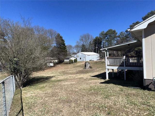 view of yard with fence and a wooden deck