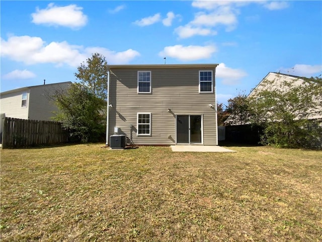 rear view of property with a patio, a yard, and central air condition unit