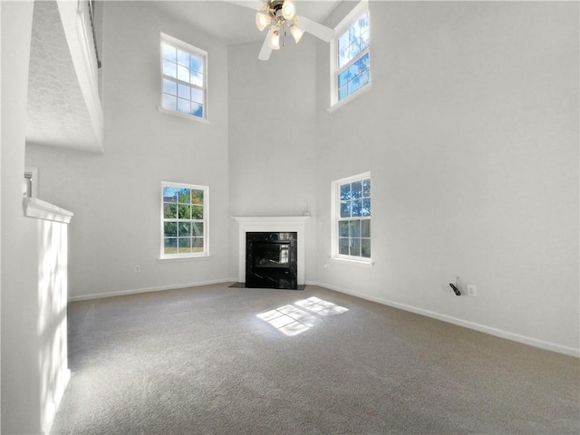 kitchen featuring kitchen peninsula, a textured ceiling, black range with gas cooktop, white fridge, and light colored carpet