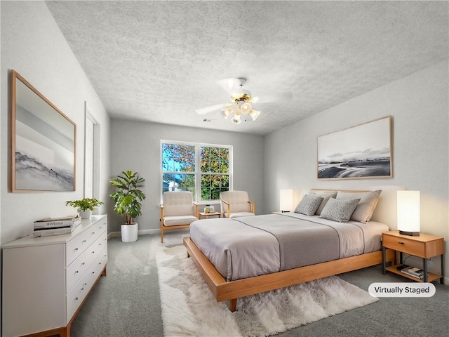 bedroom featuring carpet flooring, a textured ceiling, and ceiling fan