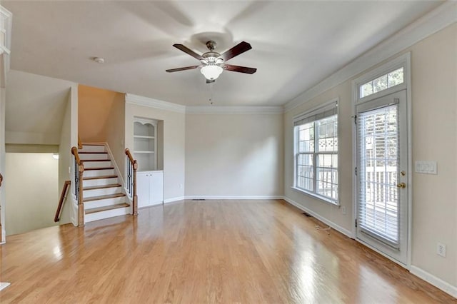 unfurnished living room with light wood-style floors, baseboards, stairway, and built in features