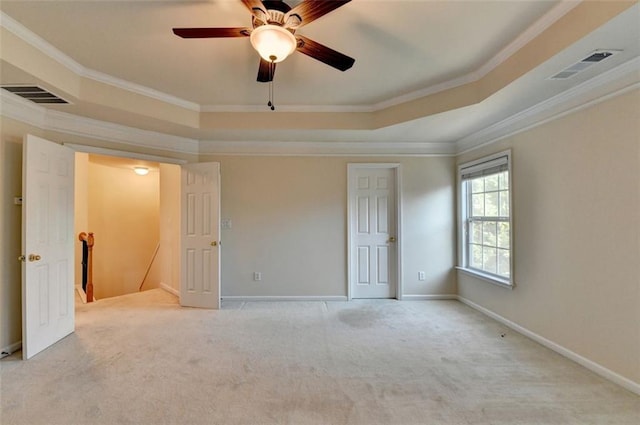 unfurnished bedroom with visible vents, a raised ceiling, and ornamental molding