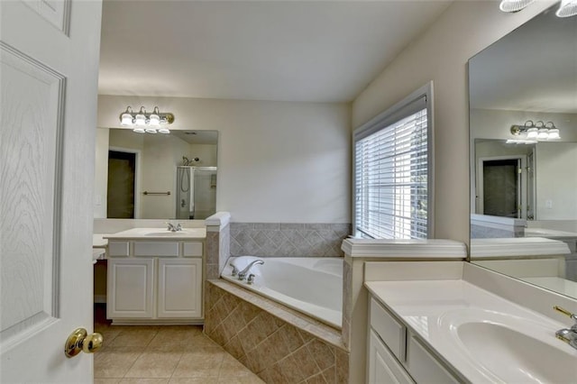 full bath featuring tile patterned flooring, two vanities, a sink, and a shower stall