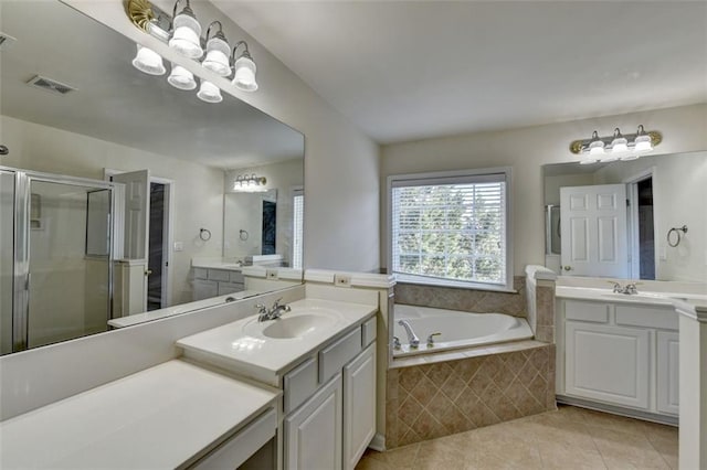 bathroom with tile patterned flooring, a sink, visible vents, a bath, and a stall shower