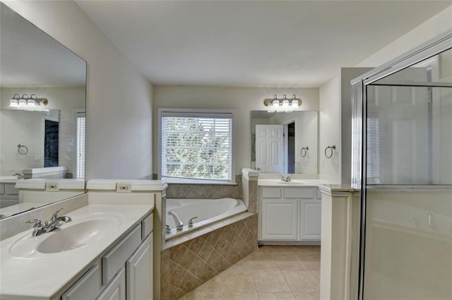 full bathroom with a stall shower, tile patterned floors, a sink, and a bath