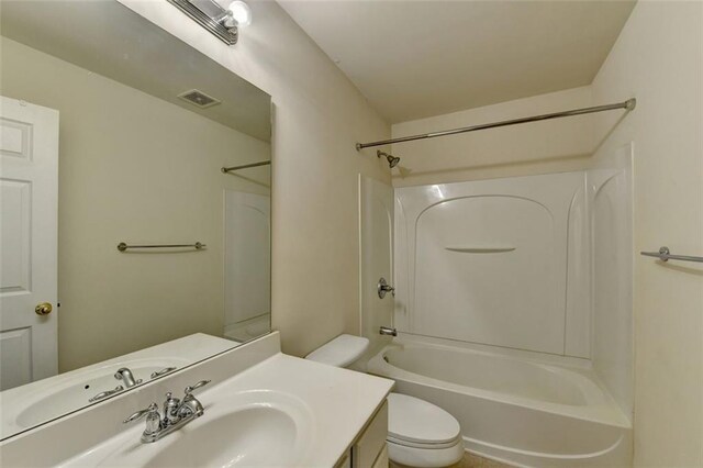 bathroom featuring visible vents, vanity, toilet, and shower / bathtub combination