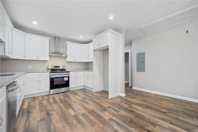 kitchen featuring wall chimney exhaust hood, white cabinetry, dark hardwood / wood-style flooring, stainless steel appliances, and light stone countertops