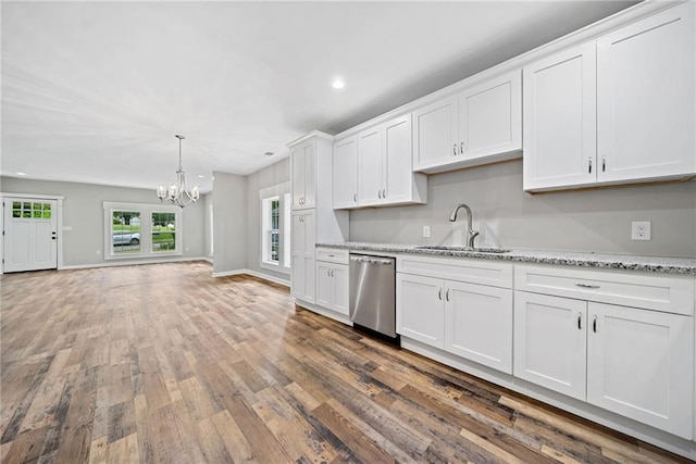 kitchen featuring dishwasher, light stone countertops, sink, and white cabinets