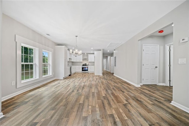 unfurnished living room with dark hardwood / wood-style flooring and a notable chandelier