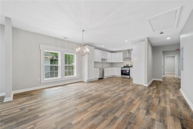 unfurnished living room featuring dark hardwood / wood-style floors and a chandelier