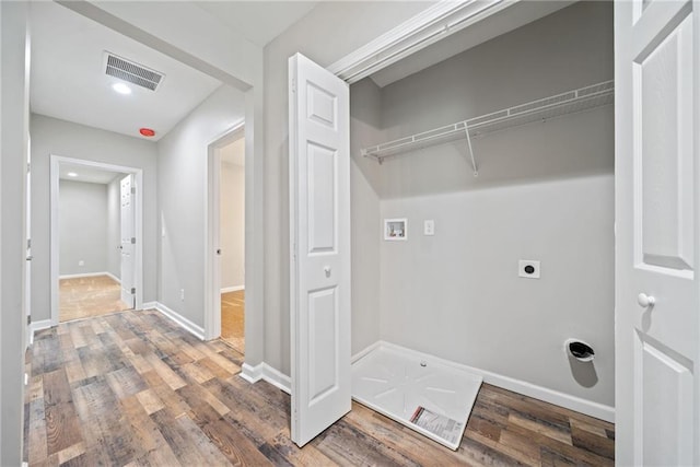 washroom with washer hookup, hardwood / wood-style floors, and electric dryer hookup