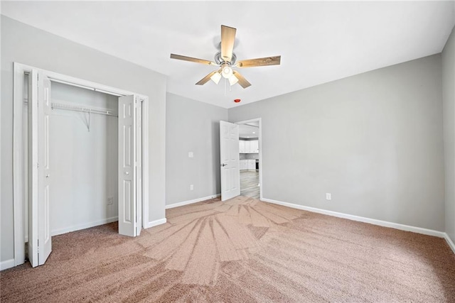 unfurnished bedroom with ceiling fan, a closet, and carpet