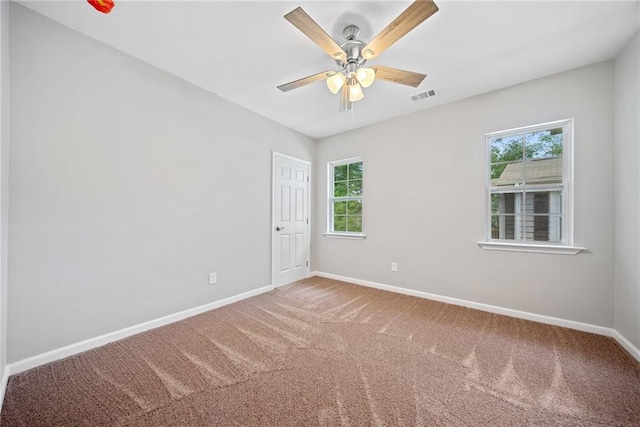 carpeted empty room featuring ceiling fan