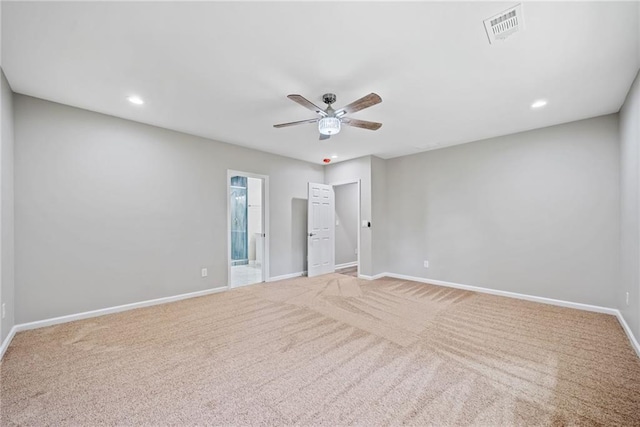 unfurnished room with light colored carpet and ceiling fan