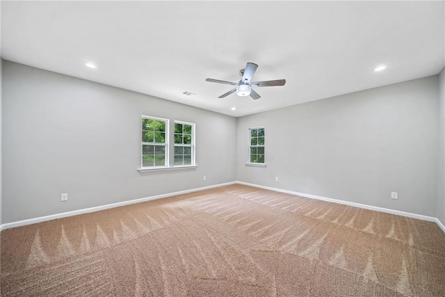 carpeted empty room featuring ceiling fan