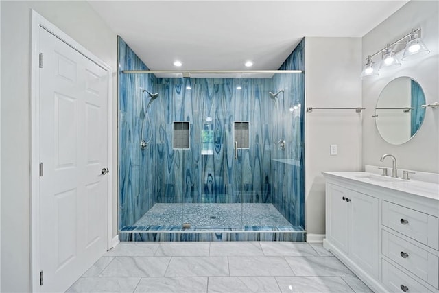 bathroom featuring tiled shower and vanity