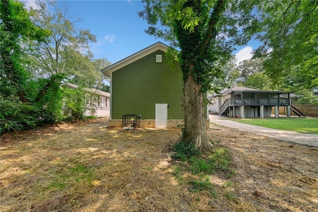 view of property exterior with a deck