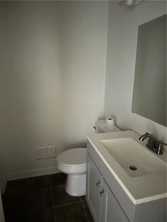 bathroom with vanity, toilet, and tile patterned floors