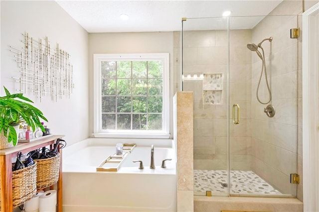 full bath featuring a garden tub and a shower stall