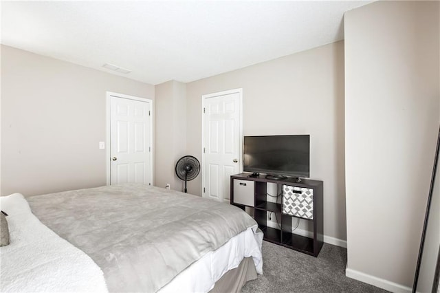 bedroom with carpet, visible vents, and baseboards