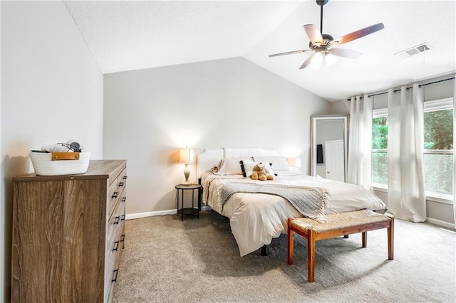 bedroom with lofted ceiling, visible vents, light carpet, and baseboards