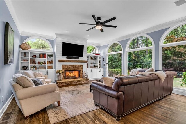 4020 Devereux Chase, Roswell, GA 30075 - living room featuring ornamental molding, ceiling fan, a stone fireplace, wood finished floors, and healthy amount of natural light