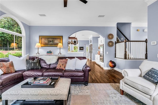 4020 Devereux Chase, Roswell, GA 30075 - living room featuring wood finished floors, ornamental molding, ceiling fan, baseboards, and arched walkways