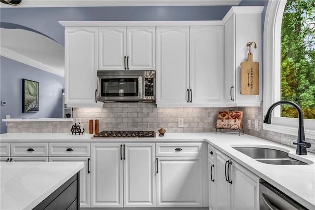 4020 Devereux Chase, Roswell, GA 30075 - kitchen with appliances with stainless steel finishes, a sink, plenty of natural light, ornamental molding, and white cabinets